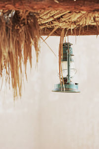 Oil lamp hanging from thatched roof