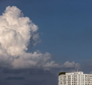 Low angle view of building against cloudy sky