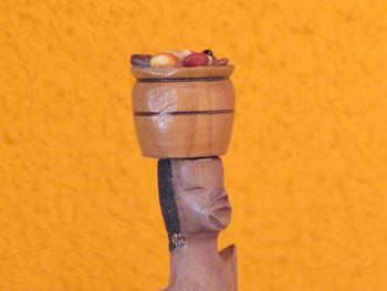 Close-up of hand holding cup against white background