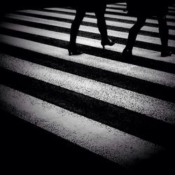 Low section of people standing on tiled floor