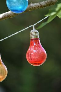 Close-up of red bell hanging outdoors