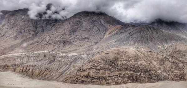 View of desert against cloudy sky