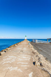 Scenic view of beach against blue sky