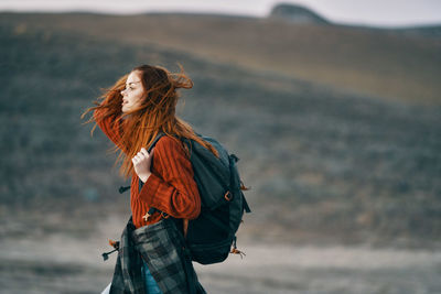 Side view of a woman standing outdoors