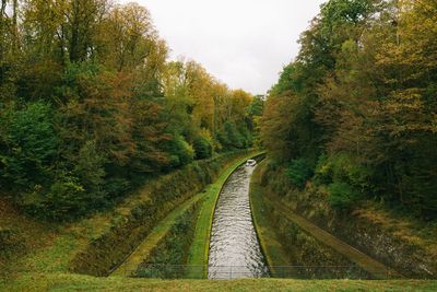 High angle view of canal amidst trees