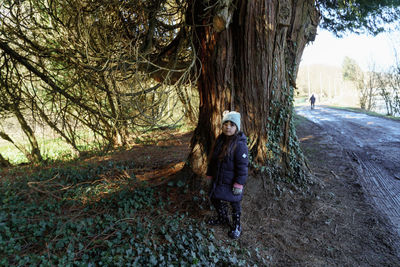 Rear view of woman walking in forest