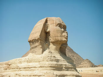 Low angle view of statue against sky