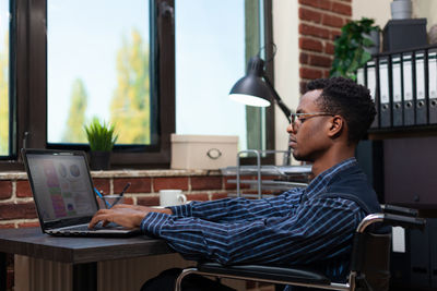 Businessman working on laptop in office