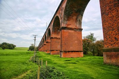 Bridge on field against sky