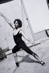 Full length male ballet dancer practicing outdoors