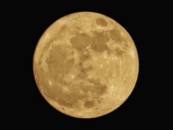 Low angle view of moon against clear sky at night