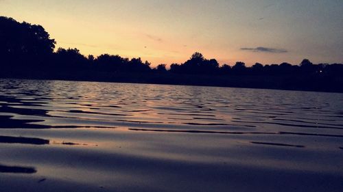 Scenic view of lake against sky at sunset