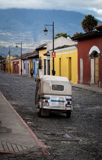 Cars on street by buildings in city