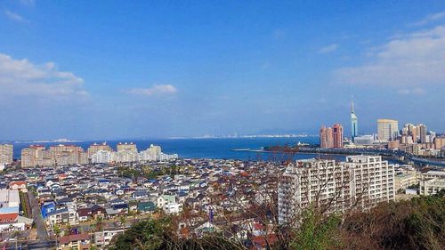 View of cityscape against blue sky