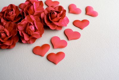 Close-up of red artificial flowers on table