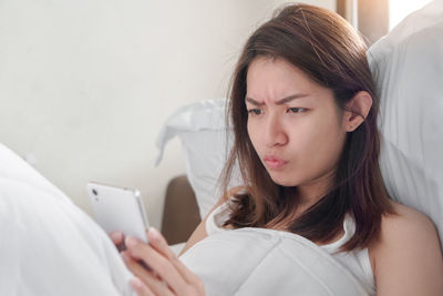 Portrait of young woman using mobile phone