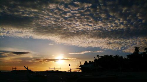 Silhouette buildings against sky during sunset