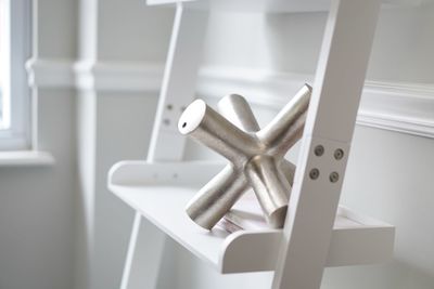 Close-up of metal railing by window at home