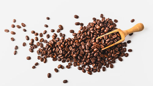 High angle view of coffee beans against white background