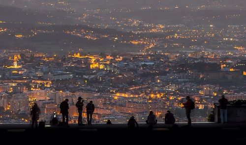 Woman in illuminated city at night