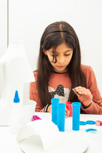 Young girl playing a life sciences professional role. could be biologist, doctor, researcher. 