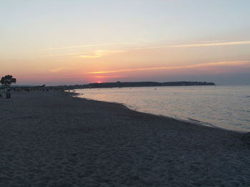 Scenic view of beach against sky during sunset