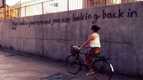 Man riding bicycle on wall