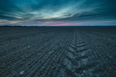 View of landscape against cloudy sky at night