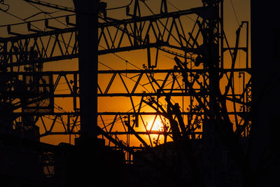 Low angle view of silhouette building against sky during sunset