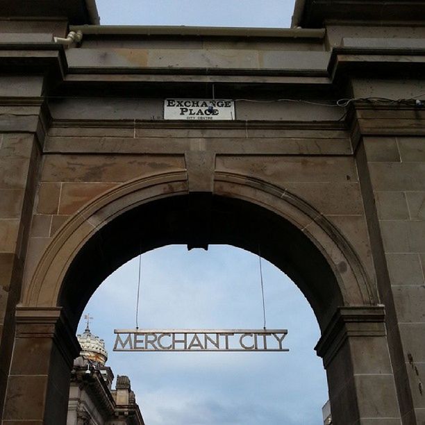 architecture, built structure, low angle view, arch, building exterior, sky, text, history, day, connection, no people, building, travel destinations, outdoors, famous place, city, communication, western script, clock, architectural column