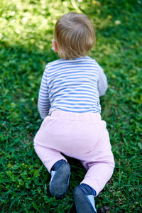 Rear view of boy on field