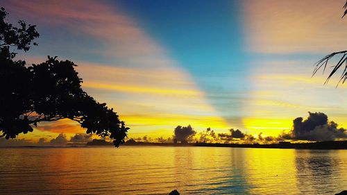 Scenic view of lake against orange sky