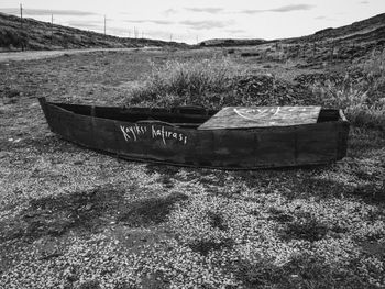 Abandoned boat moored on beach