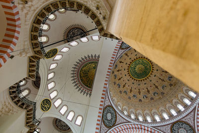 Low angle view of clock on ceiling of building