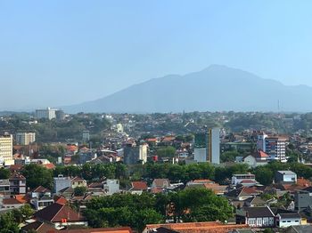 Buildings in city against clear sky