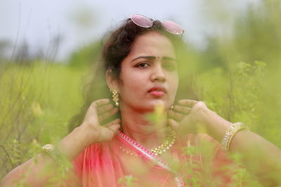 Close-up portrait of young woman on field