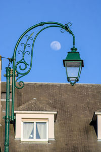 Low angle view of street light against building