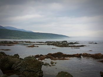 Scenic view of sea against cloudy sky