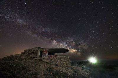 Built structure against star field at night