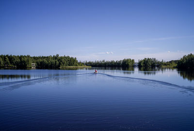 Scenic view of lake against blue sky