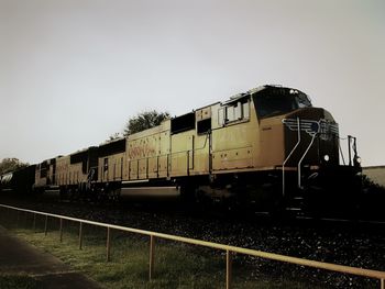 Train on railroad tracks against clear sky