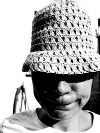 Close-up portrait of man wearing hat against white background