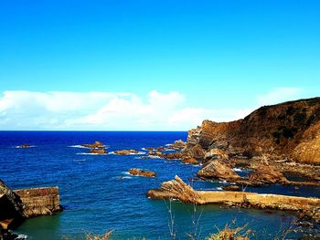 Scenic view of sea against blue sky