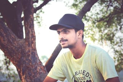 Portrait of young man looking away outdoors