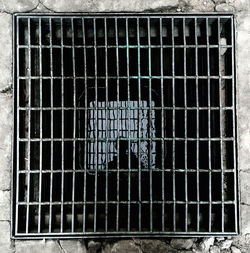 Low angle view of metal grate in cage
