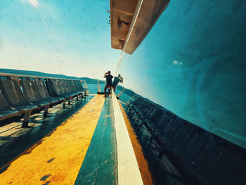 Rear view of man walking on staircase