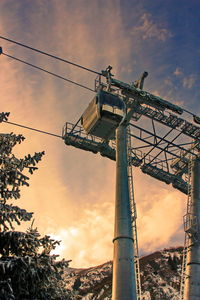 Low angle view of crane against sky during sunset