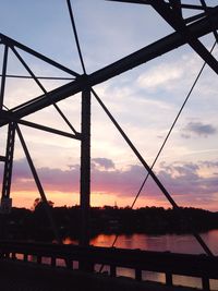 Low angle view of bridge against cloudy sky