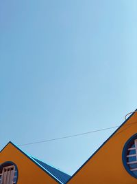 Low angle view of building against clear blue sky