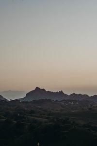 Scenic view of landscape against clear sky during sunset